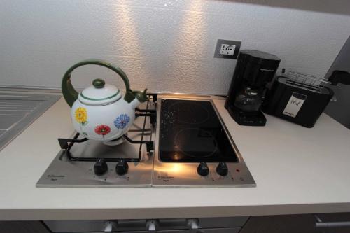 a tea pot sitting on top of a stove at Residence Rivachiara (check-in at Hotel Riviera in Viale Rovereto, 95) in Riva del Garda