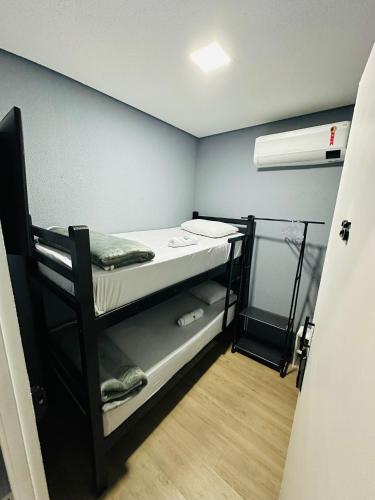 a small room with a bunk bed in it at On Hotel Campos do Jordao centro capivari e Passeio Quadriciclo in Campos do Jordão