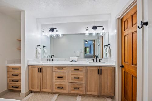 a bathroom with a sink and a mirror at Scenic Location, Sleeps 8, 5 min to Base & Bike Access, Private Hot Tub, Walk to restaurants! in Park City