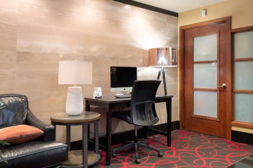 a room with a desk with a computer and a chair at Best Western Plus Columbia River Hotel in Trail