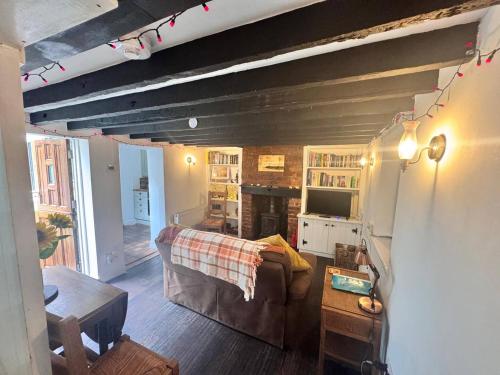 a living room with a couch and a table at Alma Cottage - 17th Century Flint Cottage in Ramsgate