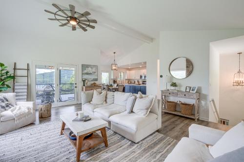 a living room with white couches and a table at Less Than 1 Mi to Lake Chatuge Home with Mtn and Water Views! in Young Harris
