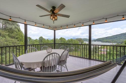 a porch with a table and chairs and a ceiling fan at Less Than 1 Mi to Lake Chatuge Home with Mtn and Water Views! in Young Harris