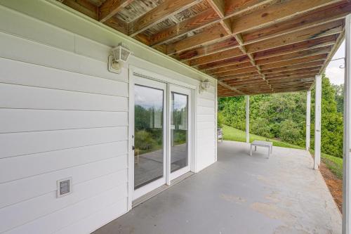 an empty porch of a house with a window at Less Than 1 Mi to Lake Chatuge Home with Mtn and Water Views! in Young Harris