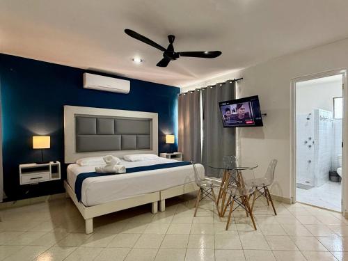 a bedroom with a bed with a blue wall at Charming Light-Filled Stay for 2 with Pool in Mérida
