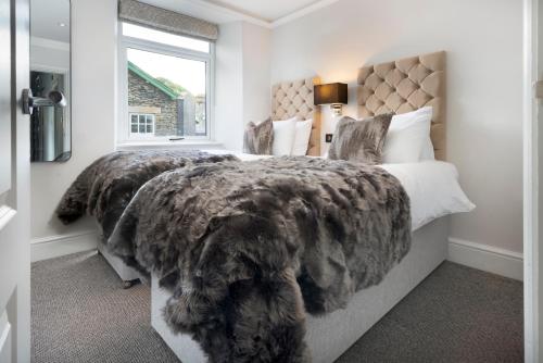 a bedroom with a dog laying on a bed at Lake Road Apartments in Bowness-on-Windermere