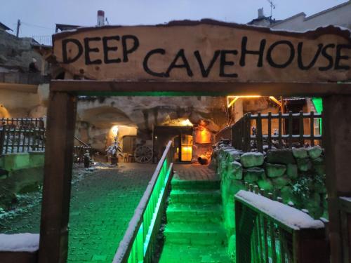 a sign for a deep house with green lights at DEEP CAVE House in Urgup