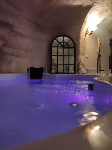 a pool of purple water in a room at DEEP CAVE House in Urgup