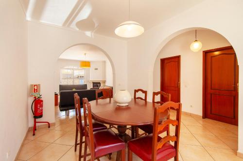 a dining room and living room with a table and chairs at FF - Sea Breeze Guesthouse in Lagos