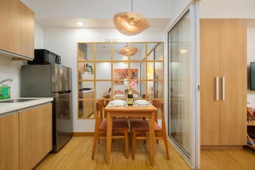 a kitchen with a table and chairs in a kitchen at Modern Rustic Home Staycation in Manila