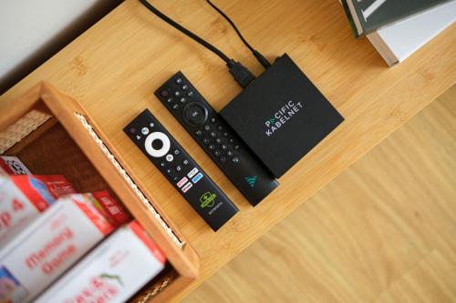 a remote control sitting on top of a table at Modern Rustic Home Staycation in Manila