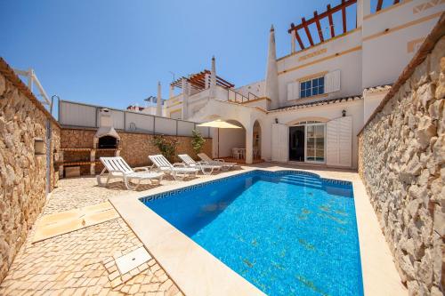 a swimming pool in front of a villa at FF - Sea Breeze Guesthouse in Lagos