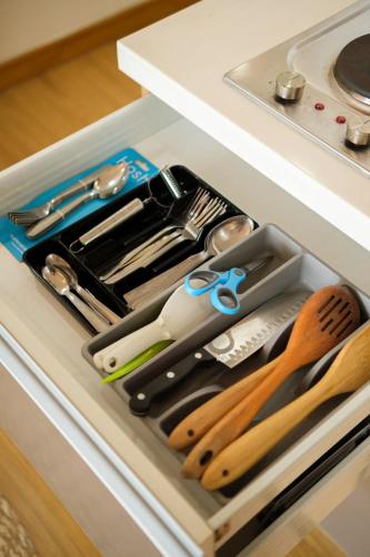 a drawer filled with kitchen utensils and scissors at Modern Rustic Home Staycation in Manila