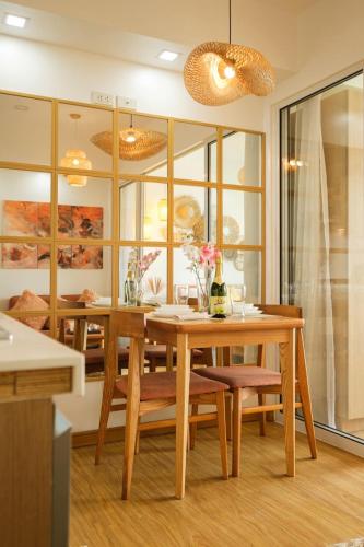 a dining room with a wooden table and chairs at Modern Rustic Home Staycation in Manila