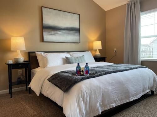 a bedroom with a bed with two bottles on it at Retreat At The Charles Top Floor Gated Parking in Dublin