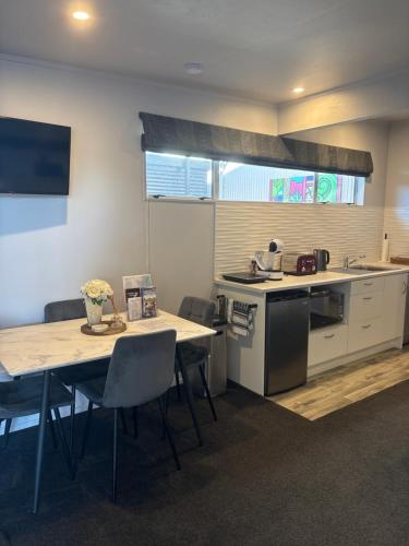 a kitchen with a table and a table and chairs at Self Contained gem in the country, near to town in Twyford
