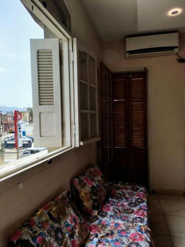 a bed in a room with a window at Nabil appartement in Taher