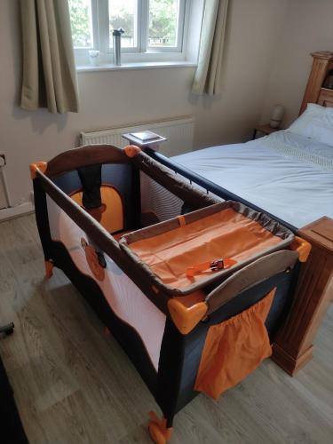 a bed in a room with a bed frame with a guitar at High Rigg House Bradford - Luxury Accomodation with Private Parking in Idle