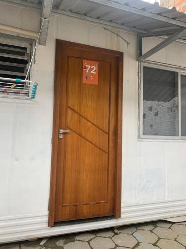 a wooden door on a building with a sign on it at Vila do Chaves Casa Seu Madruga 72 in Itajaí