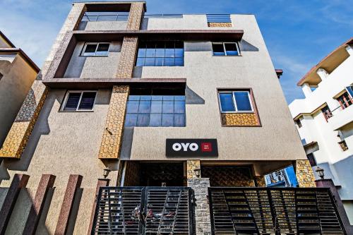 an apartment building with an ovo sign on it at Hotel O Home Bm-x in Khandagiri