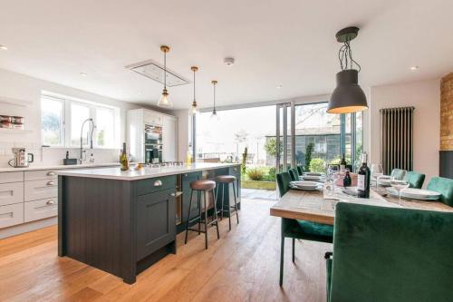 a kitchen and dining room with a table and chairs at The Old School Hall - Opulence and Location in Kent