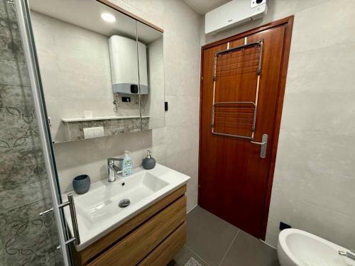 a bathroom with a sink and a toilet and a mirror at Apartment in Dramalj 54763 in Dramalj