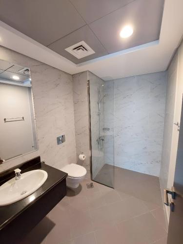 a bathroom with a toilet and a sink and a shower at Budget-friendly 2bd near EXPO with a huge pool in Dubai