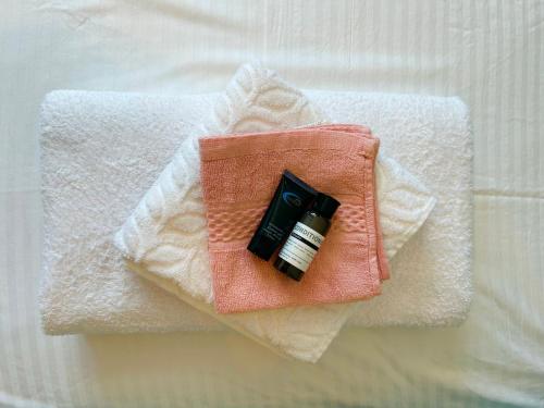a candle sitting on top of a pile of towels at Santorini Village, Drymades, Dhermi in Dhërmi