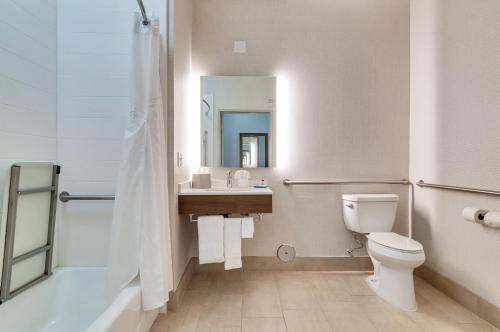 a bathroom with a toilet and a sink and a mirror at Holiday Inn Express Hotel & Suites Banning by IHG in Banning