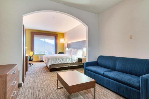 a hotel room with a bed and a couch at Holiday Inn Express Hotel & Suites Banning by IHG in Banning