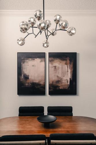 a dining room with a table and a chandelier at 3BR-3BA Modern Ybor Central Tampa with Rooftop Firepit & 2 Bikes-Fully Equipped in Tampa