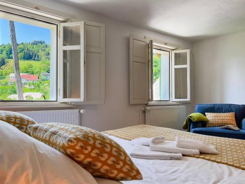 a bedroom with a bed with two towels on it at Alpine Retreat - Lake Bled in Bled