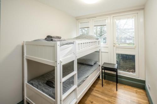 a white bunk bed in a room with a window at 4BD Townhouse - Paddington! in London