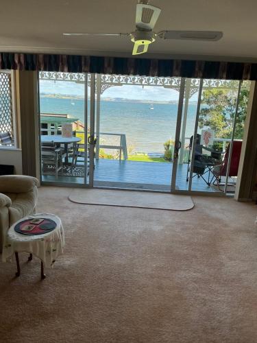 a living room with a view of the ocean at Tamaterau Seaview House in Whangarei in Whangarei