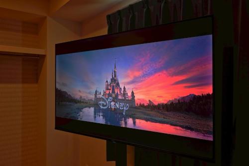 a flat screen tv hanging on a wall with a castle at v close to Noagata 15 min to Shinjuku station in Tokyo