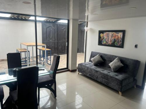 a living room with a couch and a table at Hospedaje Altamira in Guatavita