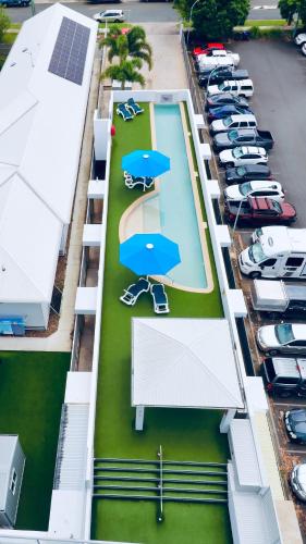 an aerial view of a parking lot with blue umbrellas at Scarborough Beach Resort Brisbane in Scarborough