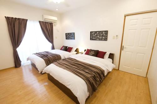 Postel nebo postele na pokoji v ubytování KIN Seaside Hills Town