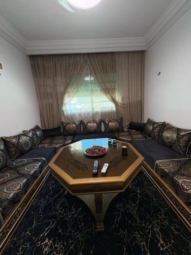a living room with a couch with a coffee table at alojamiento en tanger bab Andaluz 3 in Tangier