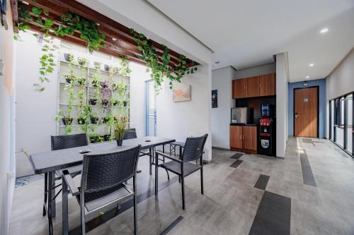 a dining room with a table and chairs at RedDoorz Plus near Radio Dalam 3 in Jakarta