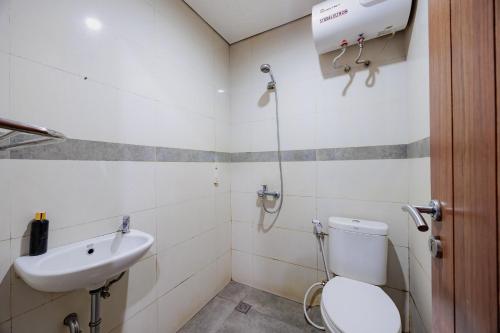 a bathroom with a toilet and a sink at RedDoorz Plus near Radio Dalam 3 in Jakarta