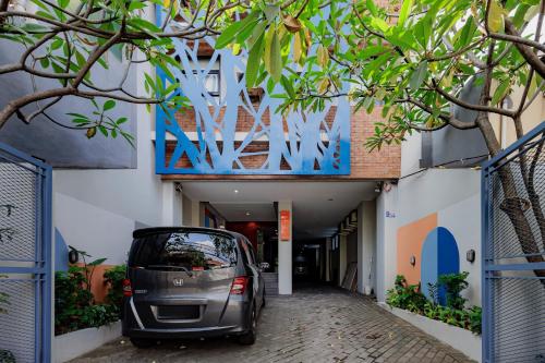 a small car parked in front of a building at RedDoorz Plus near Radio Dalam 3 in Jakarta