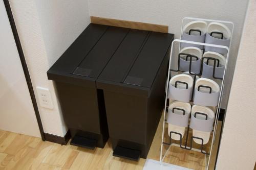 a black desk with a rack of white chairs at Amesoko 747 in Amesoko
