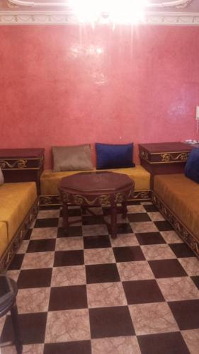 a living room with couches and a checkered floor at Tetouan Tetúan تطوان in Tetouan