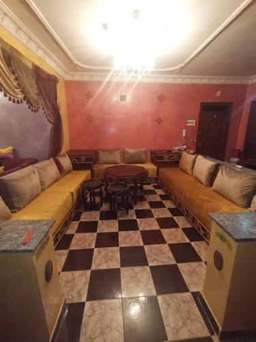 a living room with a couch and a checkerboard floor at Tetouan Tetúan تطوان in Tetouan