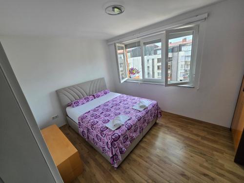 a small bedroom with a bed and a window at The Urbanite in Bihać