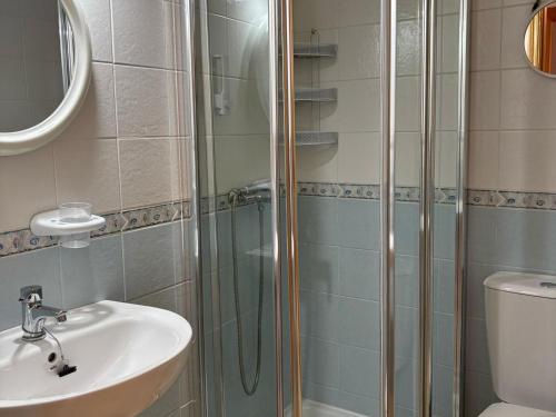 a bathroom with a glass shower and a sink at Inviting holiday home with pool in Palomares
