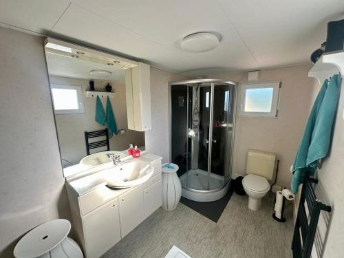 a bathroom with a sink and a shower and a toilet at Holiday home in Elim for family in Elim