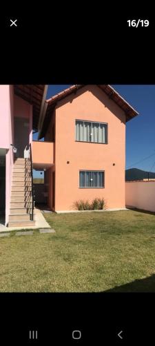 a large house with a staircase in front of it at Chalé 4 vista para montanha in Penedo
