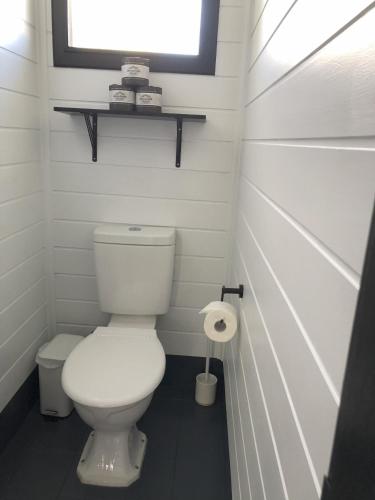 a small bathroom with a toilet and a window at Motel Maclean in Maclean